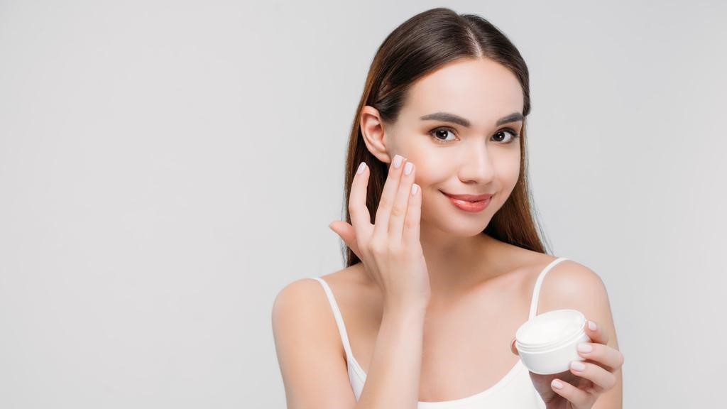 stock-photo-beautiful-girl-applying-cosmetic-cream